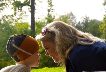 mother and son playing in park