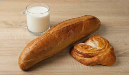 baguette, Moscow buns and milk on the table