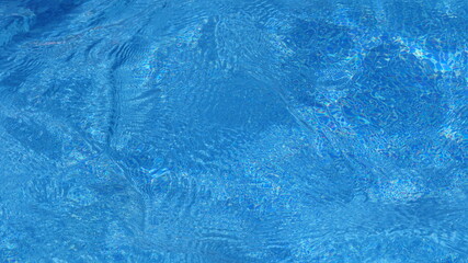 Blue swimming pool surface, water background in swimming pool.
