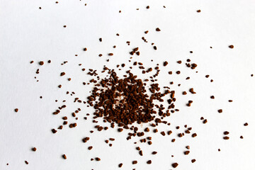 Macrophotography. Coffee granules are scattered in a heap. A handful of granulated instant brown coffee