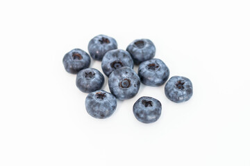 
Blueberries on a white background. And also in a glass with a yellow tube. On a gray background.