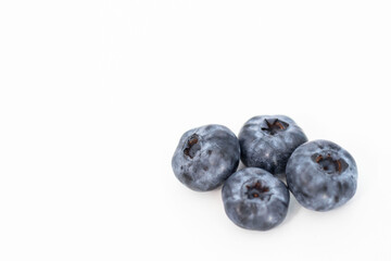 
Blueberries on a white background. And also in a glass with a yellow tube. On a gray background.