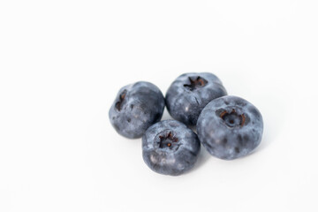 
Blueberries on a white background. And also in a glass with a yellow tube. On a gray background.