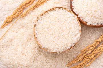 Fototapeta na wymiar Raw rice in a bowl and full frame in the white background table, top view overhead shot, close up
