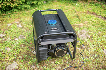 Portable gasoline generator in the open air, in nature.