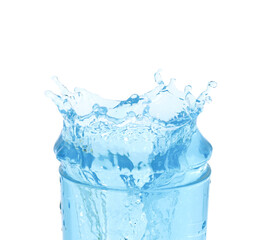 ice cubes threw into a glass of pure water and water splashes. Isolated on a white background