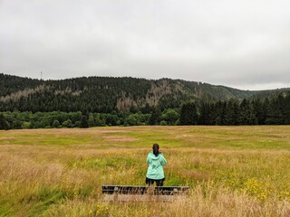 Woman in front of a bench in the field
