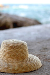 Fototapeta na wymiar Straw hat on a beach. Selective focus.