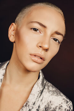 Close up vertical shot of gorgeous caucasian woman with short blonde hair and perfect skin and daily make up