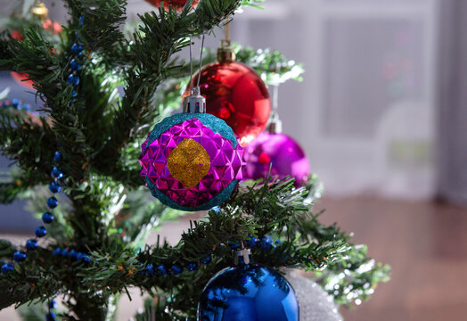 blue and pink balls on the Christmas tree in the room