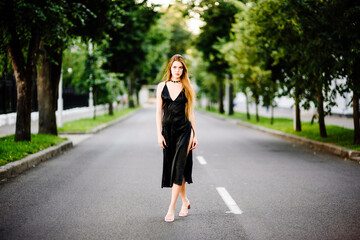 portrait beautiful girl in black dress outdoors