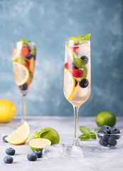 A delicious glass of mocktail with strawberry blueberry lemon and  mint