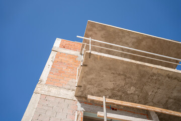 House being build. Exterior structure with brick walls and cement. Building and renovating house background. Under construction site. 