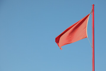 red flag indicating a dangerous situation on the background of t