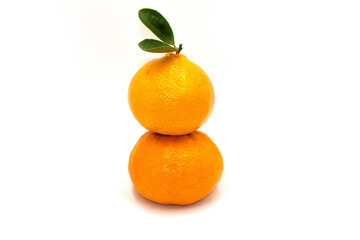 A stack of Orange with leaves isolated on white background.