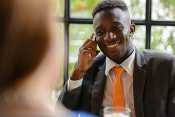 Young African businessman and young businesswoman together