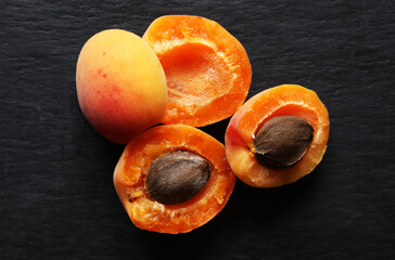 Photography of apricots open and cut in halves and apricots kernels for food background