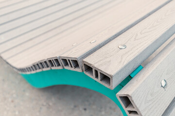Obraz premium Close-up and detailed view of the Assembly of accessories for benches and sun beds on the city embankment