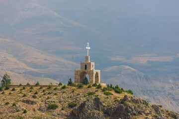Chapel and cross in the mountains in Lebanon. Panoramic view of the Kadisha Valley. The place of...