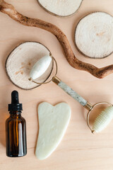 Facial massage roller and guache scraper on wood background. Advertising Beauty salon, face massage. Place for the text. Stock photography