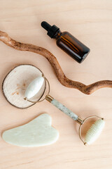 Facial massage roller and guache scraper on wood background. Advertising Beauty salon, face massage. Place for the text. Stock photography