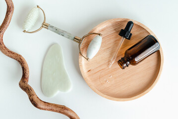 Facial massage roller and guache scraper on green background. Advertising Beauty salon, face massage. Place for the text. Stock photography