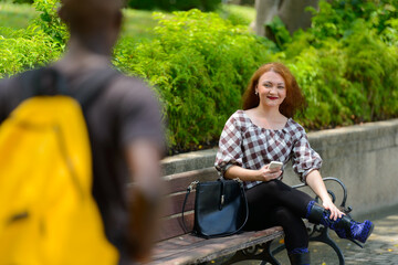 Fototapeta premium Young African man and young woman with red hair together