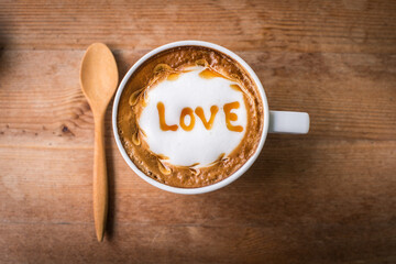 hot coffee with foam milk art, latte art coffee ( Filtered image processed vintage effect.)