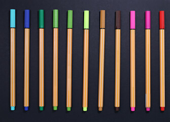 colorful flatlay fineliner pen with black background