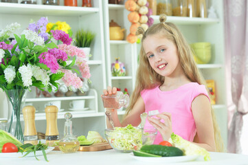 Portrait of cute girl preparing delicious fresh salad