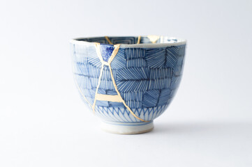 Japanese kintsugi ceramic teapot restored with real gold. Antique pottery kintsukuroi.