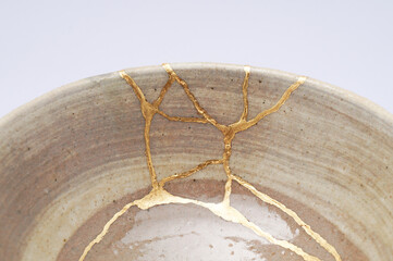 Japanese kintsugi ceramic chawan bowl restored with real gold. Antique pottery kintsukuroi.