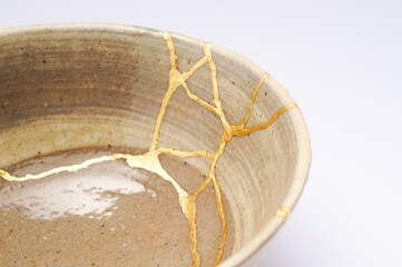 Japanese kintsugi ceramic chawan bowl restored with real gold. Antique pottery kintsukuroi.