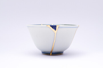 Japanese kintsugi ceramic teapot restored with real gold. Antique pottery kintsukuroi.