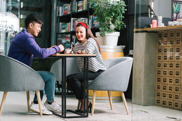 Positive couple smiling while recording videos for the blog