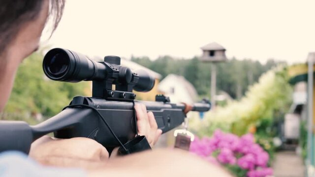 man shoots from a pneumatic sniper rifle in nature. shooting training.