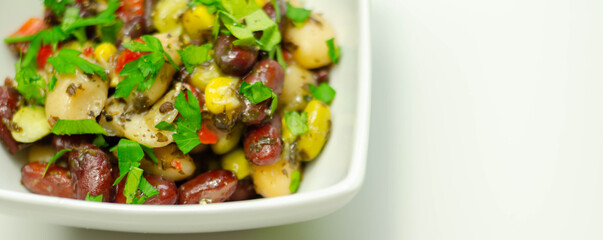 Kidney beans, butter beans and edamame beans with sweetcorn and grilled red peppers in a mint vinaigrette