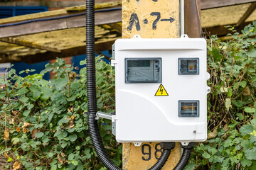 electrical panel with a warning sign on the street pole