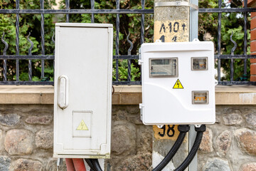 electrical panel with a warning sign on the street pole