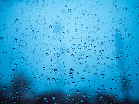 Image of water droplets on a clear glass surface during heavy rain