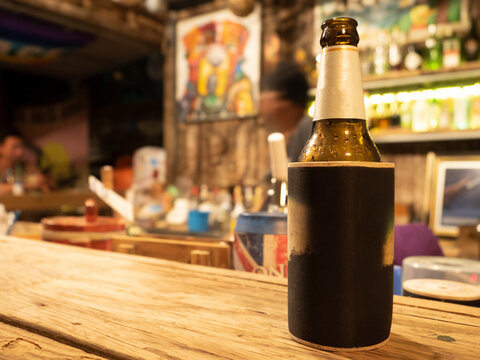 a bottle of beer in cooler on bar table. Tropical local bar in Samed island, Thailand.