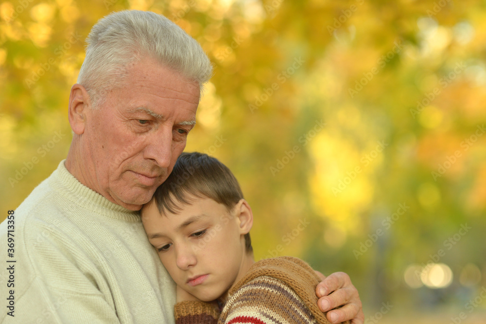 Canvas Prints Sad grandfather and grandson hugging in park