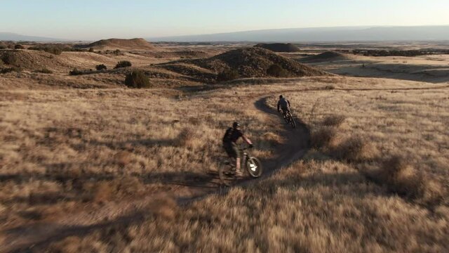 Drone follow two mountain bikers on trail near Fruita Colorado