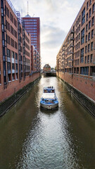 The boat goes through a canal in Hamburg