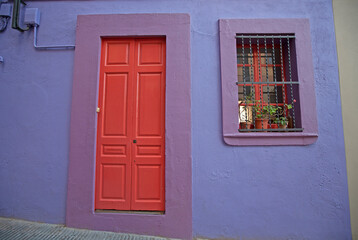 Beautiful colorful facade of an old European house with a wooden door and window