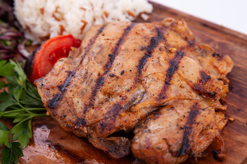 Delicious, grilled chicken steak on chopping board. Food photography