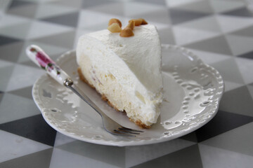 Close-up a piece of coconut cake on white plate.