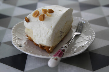 Close-up a piece of coconut cake on white plate.