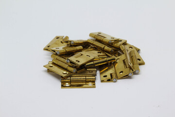 Pile of brass hinge isolated on white background.