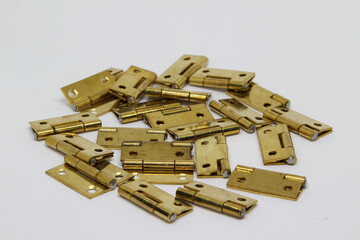 Pile of brass hinge isolated on white background.